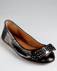 In the softest leather, Elie Tahari's Dalia flats showcase shining studs, juxtaposed by a feminine bow. In the softest leather, Elie Tahari's Dalia flats showcase shining studs, juxtaposed by a feminine bow.