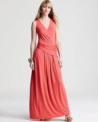 Dramatic draping infuses this vibrant Elie Tahari maxi dress with regal sensibility. Gold accents put a shine on the commanding silhouette. Dramatic draping infuses this vibrant Elie Tahari maxi dress with regal sensibility. Gold accents put a shine on the commanding silhouette.