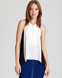 An exposed front zip adds edge to this BCBGMAXAZRIA top, featuring trend-perfect color blocking for a graphic punch. An exposed front zip adds edge to this BCBGMAXAZRIA top, featuring trend-perfect color blocking for a graphic punch.