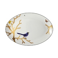 Embellished with a royal blue songbird on golden branches, this nature-inspired porcelain oval platter from Bernardaud makes an elegantly fanciful centerpiece on your table. Embellished with a royal blue songbird on golden branches, this nature-inspired porcelain oval platter from Bernardaud makes an elegantly fanciful centerpiece on your table.