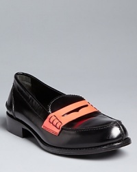 Jil Sander takes old school penny loafers new wave with dramatic neon coral accents. Jil Sander takes old school penny loafers new wave with dramatic neon coral accents.