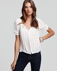 You can never have too many sleek and chic white tops. This Joie silk top has a little something different with a tie front, ruched sleeves and pleating on the back. It makes the perfect work staple with a pair of black pants and classic pumps! You can never have too many sleek and chic white tops. This Joie silk top has a little something different with a tie front, ruched sleeves and pleating on the back. It makes the perfect work staple with a pair of black pants and classic pumps!