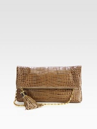 Luxurious crocodile embossed leather in a chic fold-over design accented with oversized tassel detail and radiant hardware.Detachable chain shoulder strap, 10½ dropTop zip closure with magnetic flapOne open pocket under flapOne inside zip pocketTwo inside open pocketsLeather lining13½W X 8H X 1DImported