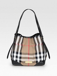 Luxurious leather accents this check printed denim style, perfect for all your essentials.Double shoulder strap, 7½ dropMagnetic snap closure with a center snap strapProtective metal feetOne inside zip pocketTwo inside open pocketsCotton lining10½W X 10¼H X 7DImported Luxurious leather accents this check printed denim style, perfect for all your essentials.Double shoulder strap, 7½ dropMagnetic snap closure with a center snap strapProtective metal feetOne inside zip pocketTwo inside open pocketsCotton lining10½W X 10¼H X 7DImported