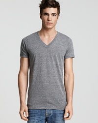Regular fit eco-heather short-sleeve v-neck tee crafted in Eco-Heather, a uniquely imperfect blend of organic cotton, recycled polyester and naturally-occurring rayon. Regular fit eco-heather short-sleeve v-neck tee crafted in Eco-Heather, a uniquely imperfect blend of organic cotton, recycled polyester and naturally-occurring rayon.