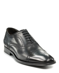 Sleek oxford with perforated upper and cap toe. Sleek oxford with perforated upper and cap toe.