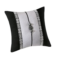 An elegant Chinoiserie-inspired decorative pillow in bold black and white, accented with a medallion and ribbon trim. An elegant Chinoiserie-inspired decorative pillow in bold black and white, accented with a medallion and ribbon trim.