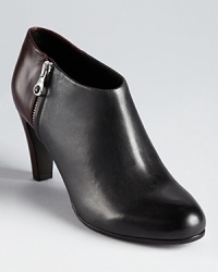See by Chloé's streamlined two-tone booties showcase a color block construction in subtle, understated hues. See by Chloé's streamlined two-tone booties showcase a color block construction in subtle, understated hues.