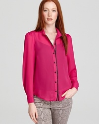 A contrast faux leather trim lends a sophisticated finish to this boldly hued blouse from Alice + Olivia. A contrast faux leather trim lends a sophisticated finish to this boldly hued blouse from Alice + Olivia.