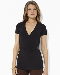 A chic faux-wrap design in figure-flattering stretch jersey is accented with elegant pleats and a luxe woven-leather detail. A chic faux-wrap design in figure-flattering stretch jersey is accented with elegant pleats and a luxe woven-leather detail.
