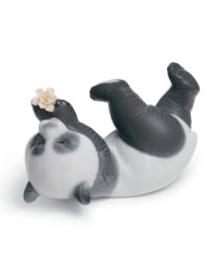 Panda at play! A lovable black and white bear tumbles onto his side, pawing at a single bloom in Lladro's artfully crafted porcelain figurine. Panda at play! A lovable black and white bear tumbles onto his side, pawing at a single bloom in Lladro's artfully crafted porcelain figurine.
