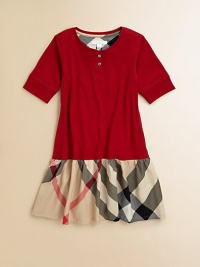 Crafted in ultra-soft cotton with snap detail, this stylish, short-sleeved frock has a full, check skirt.CrewneckShort sleevesPullover styleDrop-waistCottonMachine washImported Crafted in ultra-soft cotton with snap detail, this stylish, short-sleeved frock has a full, check skirt.CrewneckShort sleevesPullover styleDrop-waistCottonMachine washImported