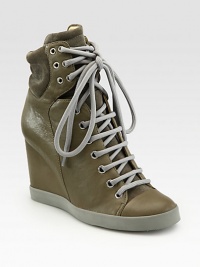 Lace-up leather hi-top sneakers revitalized by soft suede trim and a towering wedge. Self-covered wedge, 3¼ (80mm)Leather and suede upperLeather liningRubber solePadded insoleImportedOUR FIT MODEL RECOMMENDS ordering one half size up as this style runs small. Lace-up leather hi-top sneakers revitalized by soft suede trim and a towering wedge. Self-covered wedge, 3¼ (80mm)Leather and suede upperLeather liningRubber solePadded insoleImportedOUR FIT MODEL RECOMMENDS ordering one half size up as this style runs small.