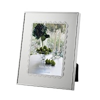 A scalloped border inspired by delicate lace lends classically feminine style to this silver-plated frame from Vera Wang. A scalloped border inspired by delicate lace lends classically feminine style to this silver-plated frame from Vera Wang.