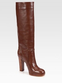Sophisticated leather design elevated by a stacked heel and platform, features raised piping and topstitching.Stacked heel, 4¼ (110mm)Stacked platform, ½ (15mm)Compares to a 3¾ heel (95mm)Shaft, 14½Leg circumference, 14Leather upperLeather lining and solePadded insoleImported Sophisticated leather design elevated by a stacked heel and platform, features raised piping and topstitching.Stacked heel, 4¼ (110mm)Stacked platform, ½ (15mm)Compares to a 3¾ heel (95mm)Shaft, 14½Leg circumference, 14Leather upperLeather lining and solePadded insoleImported