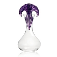 Crafted entirely by hand of weighty, sparkling crystal, this shapely Lalique wine decanter features a dramatic stopper that recalls the natural elegance of wine grapes growing on the vine. Crafted entirely by hand of weighty, sparkling crystal, this shapely Lalique wine decanter features a dramatic stopper that recalls the natural elegance of wine grapes growing on the vine.