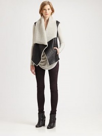 An oversized layering piece crafted of textured leather lined with ultra-soft shearling. Asymmetrical neckline with shearling trimSleevelessFront clasp closureFront slash pocketsAbout 30½ from shoulder to hemBody: LambskinLining: Genuine lamb shearlingDry clean with fur specialistImported of Italian fabricFur origin: ChinaModel shown is 5'10 (177cm) wearing US size Small. An oversized layering piece crafted of textured leather lined with ultra-soft shearling. Asymmetrical neckline with shearling trimSleevelessFront clasp closureFront slash pocketsAbout 30½ from shoulder to hemBody: LambskinLining: Genuine lamb shearlingDry clean with fur specialistImported of Italian fabricFur origin: ChinaModel shown is 5'10 (177cm) wearing US size Small.
