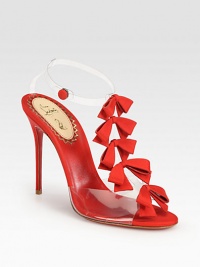 Feminine grosgrain ribbon bows line this t-strap silhouette of translucent PVC, finished with a signature red sole. Grosgrain ribbon-covered heel, 4¼ (110mm)Grosgrain ribbon and PVC upperAnkle strap with snap closureLeather liningSignature red leather solePadded insoleMade in Italy Feminine grosgrain ribbon bows line this t-strap silhouette of translucent PVC, finished with a signature red sole. Grosgrain ribbon-covered heel, 4¼ (110mm)Grosgrain ribbon and PVC upperAnkle strap with snap closureLeather liningSignature red leather solePadded insoleMade in Italy