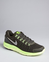 These sporty sneakers feature an accelerated high-energy design with neon accents and sci-fi inspired ribbing at the outer sole. From Nike, classic and contemporary with an unwavering focus on athletic performance. These sporty sneakers feature an accelerated high-energy design with neon accents and sci-fi inspired ribbing at the outer sole. From Nike, classic and contemporary with an unwavering focus on athletic performance.