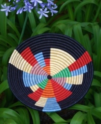 Bold, colorful and intriguingly abstract, the New Africa Fruit Bowl is true modern art. Brightly colored wedges of varying sizes and shapes emanate out from the center of the bowl, symbolizing the women of Rwanda reaching across the boundaries of gender and geography to positively impact thousands of lives-from the weavers who make the baskets to the customers whose lives are enriched by their art. Bold, colorful and intriguingly abstract, the New Africa Fruit Bowl is true modern art. Brightly colored wedges of varying sizes and shapes emanate out from the center of the bowl, symbolizing the women of Rwanda reaching across the boundaries of gender and geography to positively impact thousands of lives-from the weavers who make the baskets to the customers whose lives are enriched by their art.