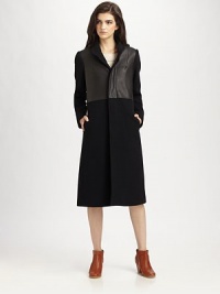 Ageless, wool-rich coat with gleaming leather trim and convenient slash pockets. Button frontLong sleevesSlash pocketsAbout 42 from shoulder to hemBody: 75% wool/25% nylon; Contrast: LeatherDry clean with leather specialistMade in USAModel shown is 5'10 (177cm) wearing US size 2. Ageless, wool-rich coat with gleaming leather trim and convenient slash pockets. Button frontLong sleevesSlash pocketsAbout 42 from shoulder to hemBody: 75% wool/25% nylon; Contrast: LeatherDry clean with leather specialistMade in USAModel shown is 5'10 (177cm) wearing US size 2.