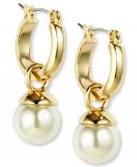 A fashionable classic. These Anne Klein earrings feature a small hoop design with an imitation pearl drop. Crafted in gold tone mixed metal. Silver tone click backing. Approximated drop: 1/2 inch. A fashionable classic. These Anne Klein earrings feature a small hoop design with an imitation pearl drop. Crafted in gold tone mixed metal. Silver tone click backing. Approximated drop: 1/2 inch.