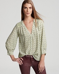 This feminine, floral printed Joie top lends effortless elegance to any ensemble. This feminine, floral printed Joie top lends effortless elegance to any ensemble.