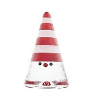 This striped Kosta Boda cone-shaped Santa figurine, designed by Anna Ehrner, is crafted a charming, festive holiday accent.