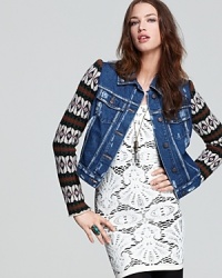 This subtly distressed Free People denim jacket boasts cozy knit sleeves for a striking two-in-one look. This subtly distressed Free People denim jacket boasts cozy knit sleeves for a striking two-in-one look.