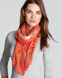 Patchwork prints in complementary colors define this luxe bohemian scarf from Tory Burch. Patchwork prints in complementary colors define this luxe bohemian scarf from Tory Burch.