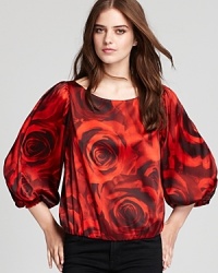 A romantic print of crimson-colored roses in full bloom brings this stunning Alice + Olivia top to life and the center of attention. A romantic print of crimson-colored roses in full bloom brings this stunning Alice + Olivia top to life and the center of attention.