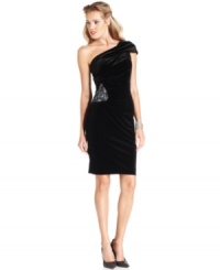 This chic velvet one-shoulder dress from Xscape is gathered with a brilliant sequined embellishment at the waist. This chic velvet one-shoulder dress from Xscape is gathered with a brilliant sequined embellishment at the waist.