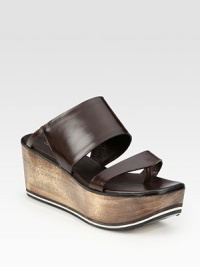 Burnished leather slide enhanced by a natural wooden wedge, slight thong front and foam insert. Wooden wedge with foam insert, 3 (75mm)Wooden platform with foam insert, 1½ (40mm)Compares to a 1½ heel (40mm)Leather upperLeather lining and solePadded insoleMade in ItalyOUR FIT MODEL RECOMMENDS ordering one half size up as this style runs small. Burnished leather slide enhanced by a natural wooden wedge, slight thong front and foam insert. Wooden wedge with foam insert, 3 (75mm)Wooden platform with foam insert, 1½ (40mm)Compares to a 1½ heel (40mm)Leather upperLeather lining and solePadded insoleMade in ItalyOUR FIT MODEL RECOMMENDS ordering one half size up as this style runs small.