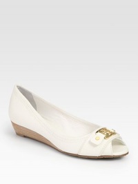 Leather peep toe silhouette with a slight stacked heel, fronted by a goldtone designer emblem. Stacked wooden wedge, 1 (25mm)Leather upperLeather liningRubber solePadded insoleImportedOUR FIT MODEL RECOMMENDS ordering true size. Leather peep toe silhouette with a slight stacked heel, fronted by a goldtone designer emblem. Stacked wooden wedge, 1 (25mm)Leather upperLeather liningRubber solePadded insoleImportedOUR FIT MODEL RECOMMENDS ordering true size.