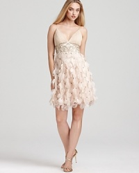 Sweet but not so innocent, this softly petaled dress is a statement in pure femininity. Pleated v-neckline stops at an inset empire waist bedazzled with tonal beads and sequins. Petal skirt ends with a bouncy bubble hem. With adjustable, lingerie straps and built-in bra padded lining. Invisible side zip with hook/eye closure. Sweet but not so innocent, this softly petaled dress is a statement in pure femininity. Pleated v-neckline stops at an inset empire waist bedazzled with tonal beads and sequins. Petal skirt ends with a bouncy bubble hem. With adjustable, lingerie straps and built-in bra padded lining. Invisible side zip with hook/eye closure.