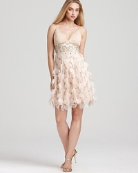 Sweet but not so innocent, this softly petaled dress is a statement in pure femininity. Pleated v-neckline stops at an inset empire waist bedazzled with tonal beads and sequins. Petal skirt ends with a bouncy bubble hem. With adjustable, lingerie straps and built-in bra padded lining. Invisible side zip with hook/eye closure.