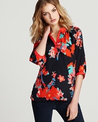 An Aqua henley shirt, designed with a vivid floral print, is a budding sensation when paired with staple black pants for new-season style. An Aqua henley shirt, designed with a vivid floral print, is a budding sensation when paired with staple black pants for new-season style.