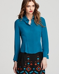 This silk Nanette Lepore top is detailed with a pleated hem and gold button at the collar, adding femininity to the luxurious staple. Team with a tribal-print skirt for workweek chic. This silk Nanette Lepore top is detailed with a pleated hem and gold button at the collar, adding femininity to the luxurious staple. Team with a tribal-print skirt for workweek chic.