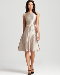 A swing skirt lends a ladylike look to this belted Anne Klein dress, rendered in a shimmering metallic fabric. A swing skirt lends a ladylike look to this belted Anne Klein dress, rendered in a shimmering metallic fabric.