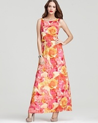 Garden party glam -- a dramatic low scoop back and floor-sweeping maxi length give this rose print Alice + Olivia dress high-style appeal. Garden party glam -- a dramatic low scoop back and floor-sweeping maxi length give this rose print Alice + Olivia dress high-style appeal.