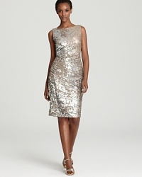 In gilded, gleaming sequins, David Meister's sparkling dress shows off a boat neck front--a chic contrast to an alluring open back. In gilded, gleaming sequins, David Meister's sparkling dress shows off a boat neck front--a chic contrast to an alluring open back.