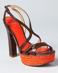 A captivating orange platform infuses instant color into a pair of strappy sandals from Aqua. A captivating orange platform infuses instant color into a pair of strappy sandals from Aqua.