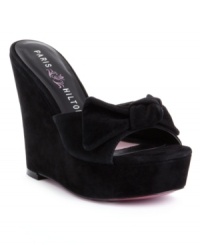 Luxe suede and a pretty decorative bow team up to make the Stephanie wedge sandals by Paris Hilton an instant favorite. Luxe suede and a pretty decorative bow team up to make the Stephanie wedge sandals by Paris Hilton an instant favorite.