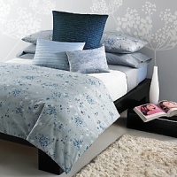 Freshly painted flowers in tones of blue fall on a textured ground. Duvet has a hidden button closure. Duvets and shams are self reversing. Freshly painted flowers in tones of blue fall on a textured ground. Duvet has a hidden button closure. Duvets and shams are self reversing.
