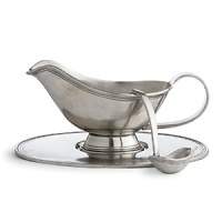 The antique patina finish and old-world shapes in this collection date back to Renaissance days. Crafted of high-quality pewter, which is completely food safe and retains its beauty and luster without maintenance. From back: Gravy boat with ladle, Butter dish with knife, Sugar/Creamer. The antique patina finish and old-world shapes in this collection date back to Renaissance days. Crafted of high-quality pewter, which is completely food safe and retains its beauty and luster without maintenance. From back: Gravy boat with ladle, Butter dish with knife, Sugar/Creamer.