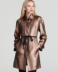 Bronze without the sun. This high-drama MARC BY MARC JACOBS coat takes the trench to haute levels this season with rich color, a covered placket and a matte tie belt. Bronze without the sun. This high-drama MARC BY MARC JACOBS coat takes the trench to haute levels this season with rich color, a covered placket and a matte tie belt.
