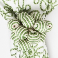 Brightly striped beads and baubles give this Juliska napkin ring a whimsical, homespun look. Brightly striped beads and baubles give this Juliska napkin ring a whimsical, homespun look.