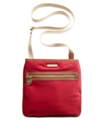Function meets fabulous with this go-everywhere accessory in smooth nylon from MICHAEL Michael Kors. The compact yet surprisingly spacious silhouette combines a practical crossbody strap and luxe 18k gold custom hardware in a lightweight, sleek design. Function meets fabulous with this go-everywhere accessory in smooth nylon from MICHAEL Michael Kors. The compact yet surprisingly spacious silhouette combines a practical crossbody strap and luxe 18k gold custom hardware in a lightweight, sleek design.