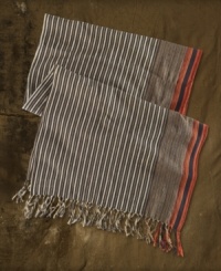 This woven cotton scarf takes a cue from rustic tribal designs with richly hued stripes and bold fringe accents. This woven cotton scarf takes a cue from rustic tribal designs with richly hued stripes and bold fringe accents.