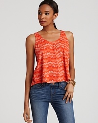 A vibrant print packs a punch on this ALTERNATIVE tank -- an ideal companion to skirts and jeans alike. A vibrant print packs a punch on this ALTERNATIVE tank -- an ideal companion to skirts and jeans alike.